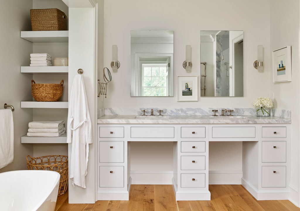 bathroom with white cabinets, walls and countertops and hardwood floor