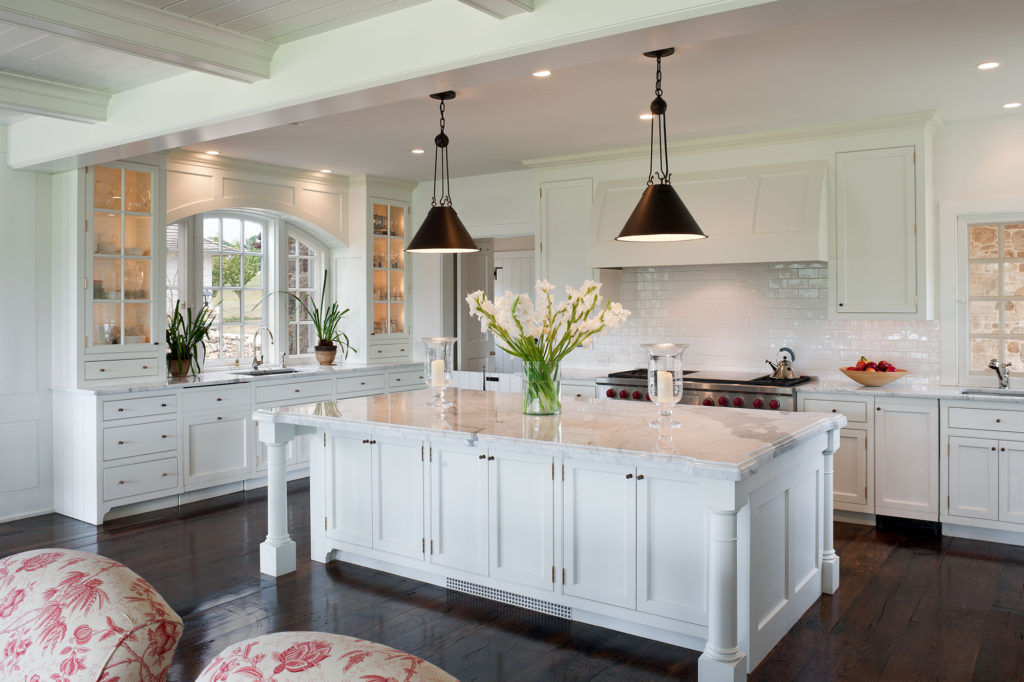 kitchen with white counter tops, cabinets and backsplash