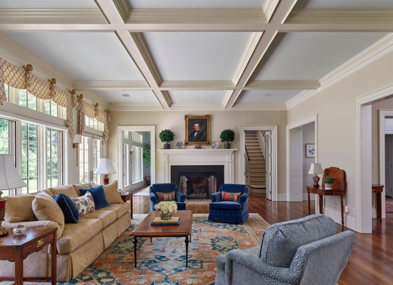 living room with coffered ceiling and fireplace