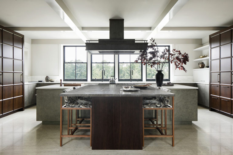 Contemporary kitchen with dark wood and metal cabinets, large island, and dark metal window frames