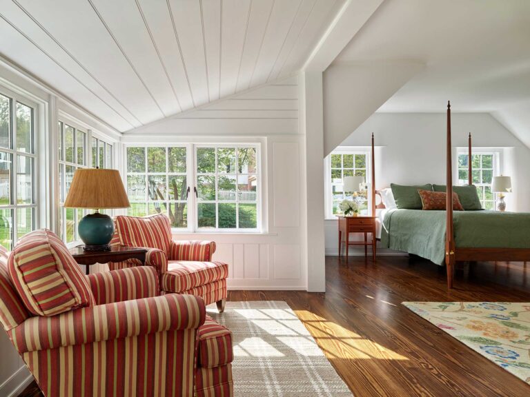 a new sitting area reminiscent of the original sleeping porch adjoins the new primary bedroom in the addition at Dower House