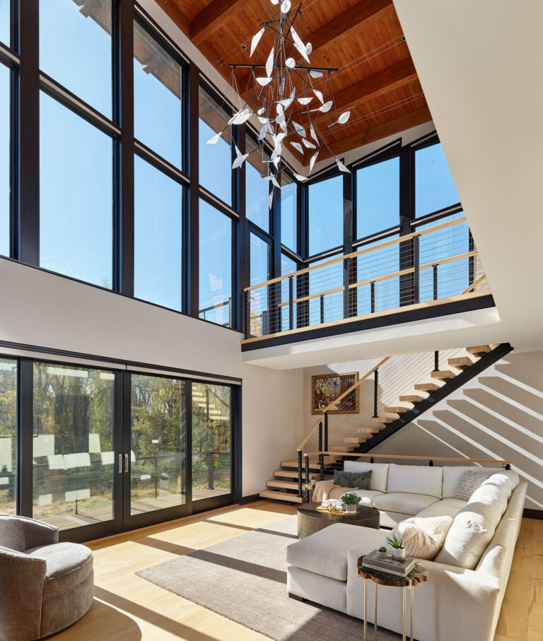 living room space in modern home design open to second floor and with views