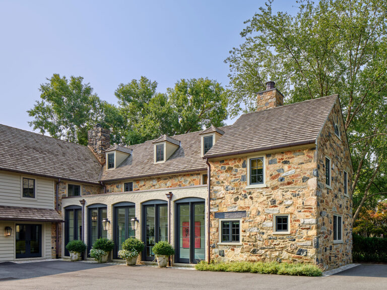 exterior showing infill addition of loggia in renovation of 1950s colonial revival home