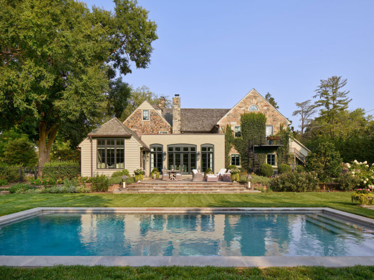 view showing addition to 1950s colonial revival home over pool and gardens