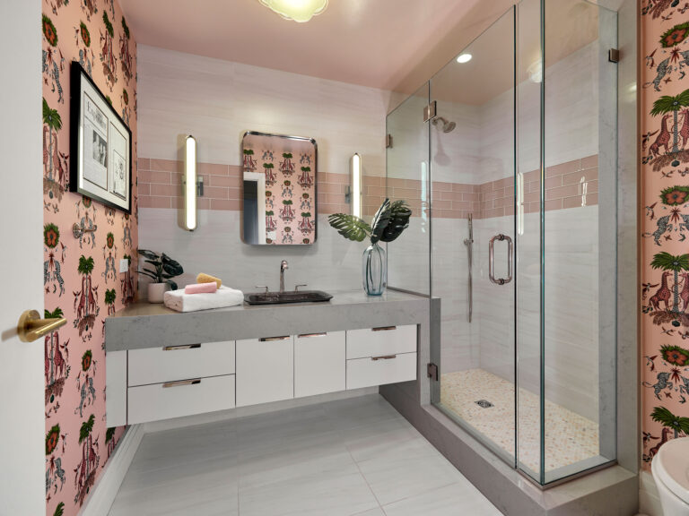 Pink, white and gray guest bathroom with pink wallpaper in Rittenhouse Square condominium renovation