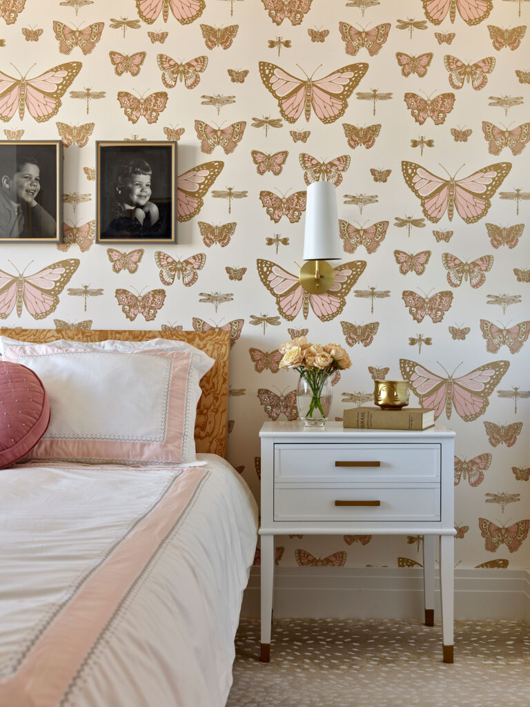 Pink and white primary bedroom with butterfly wallpaper in Rittenhouse Square Condominium