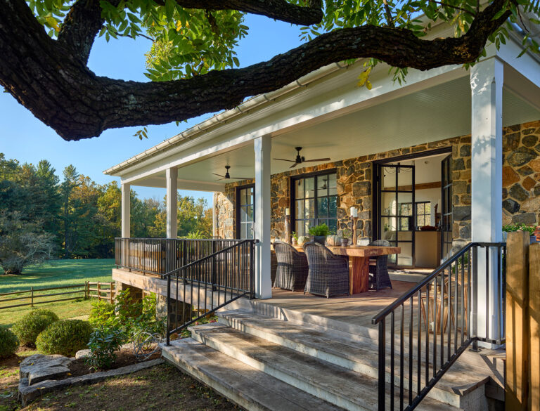 Covered porch dining and gathering space outside of great room at Strand Millas in Rockland Delaware