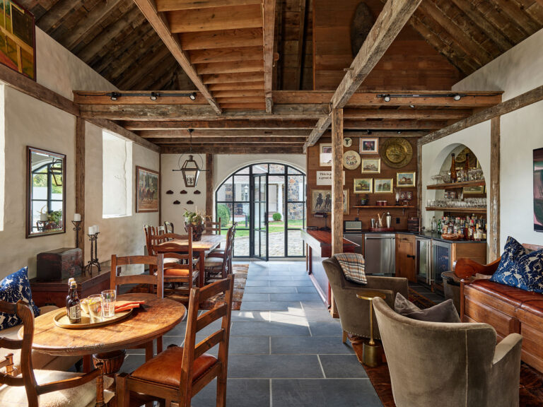 Interior view of bar and gathering areas in dog kennel transformed into a private pub at Strand Millas